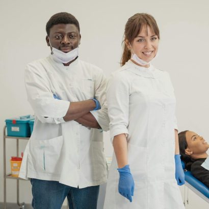 Dentists with patient in a dental clinic providing healthcare services.